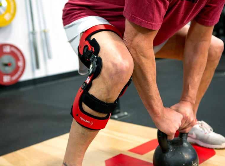 man exercising in gym while wearing rebel brace